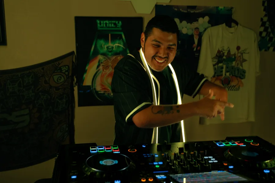 Smiling and vibing while DJing a live set